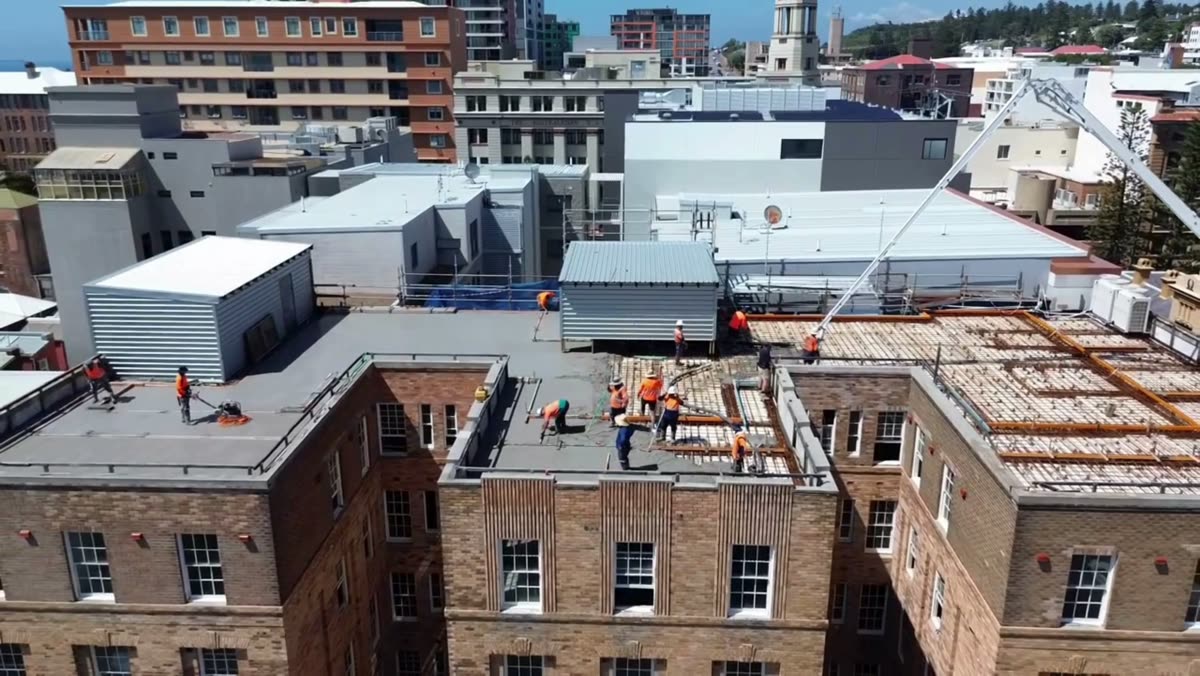 Aerial view of a METCON crew working on a commercial building rooftop in Sydney
