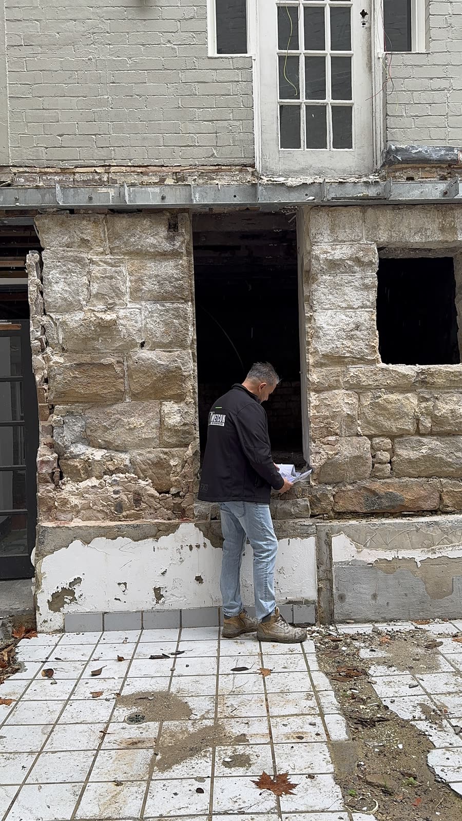 METCON director inspecting heritage sandstone walls during remedial works