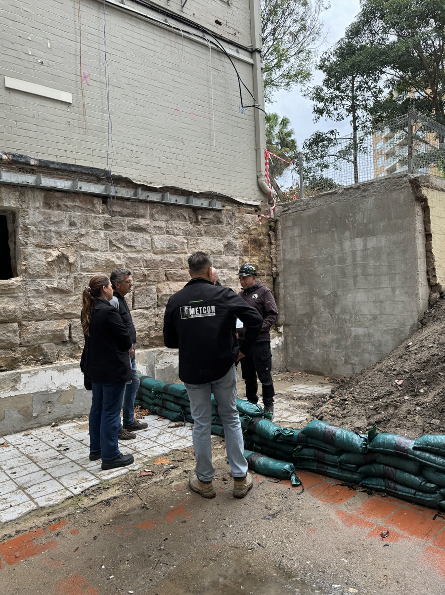 METCON team reviewing a heritage sandstone site with the client