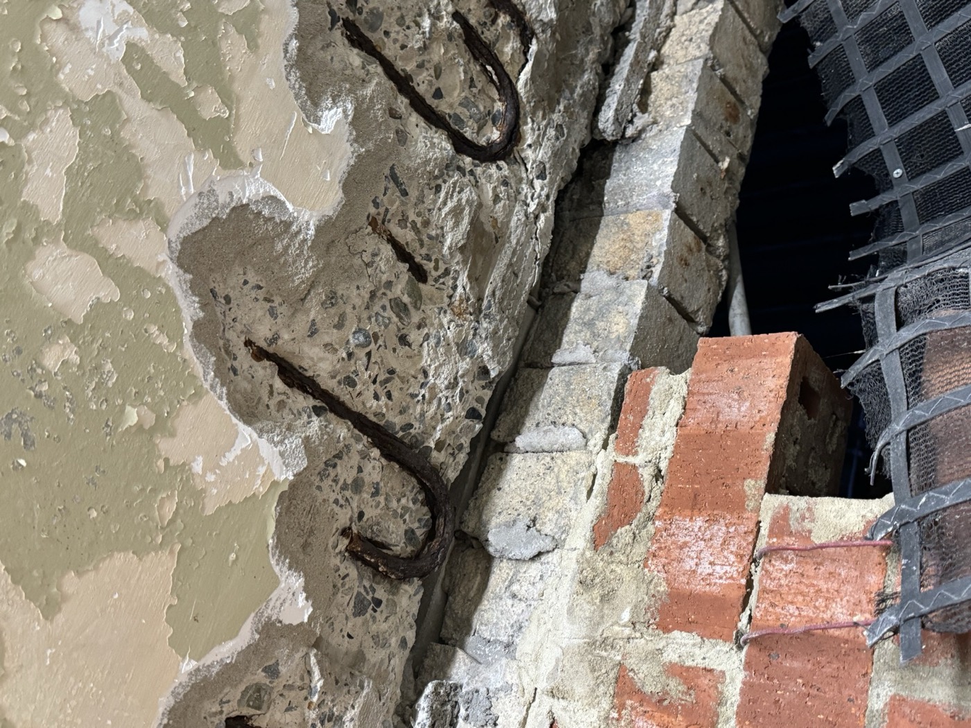 Spalled concrete with exposed reinforcement before repair