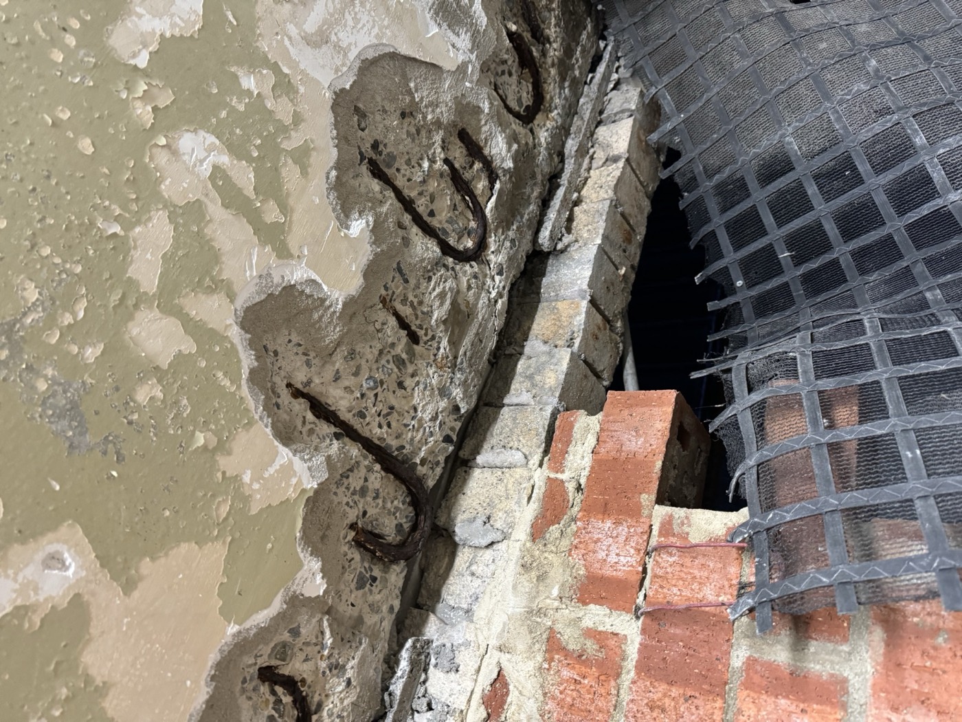 Spalled concrete cut back to the steel