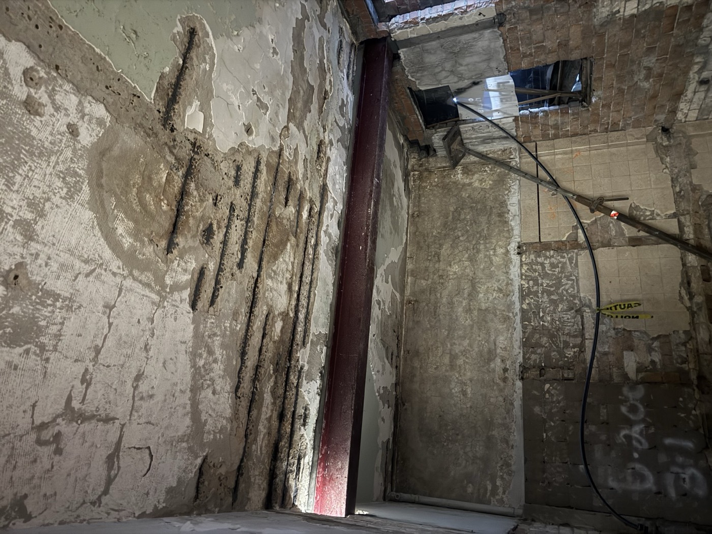 Failed steel and spalling concrete
